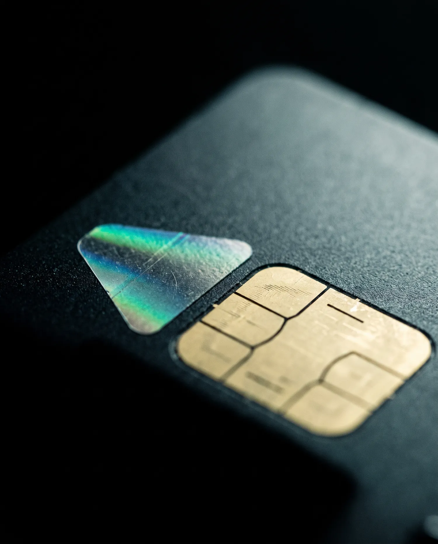 Extreme macro of a payment card chip module and holographic foil